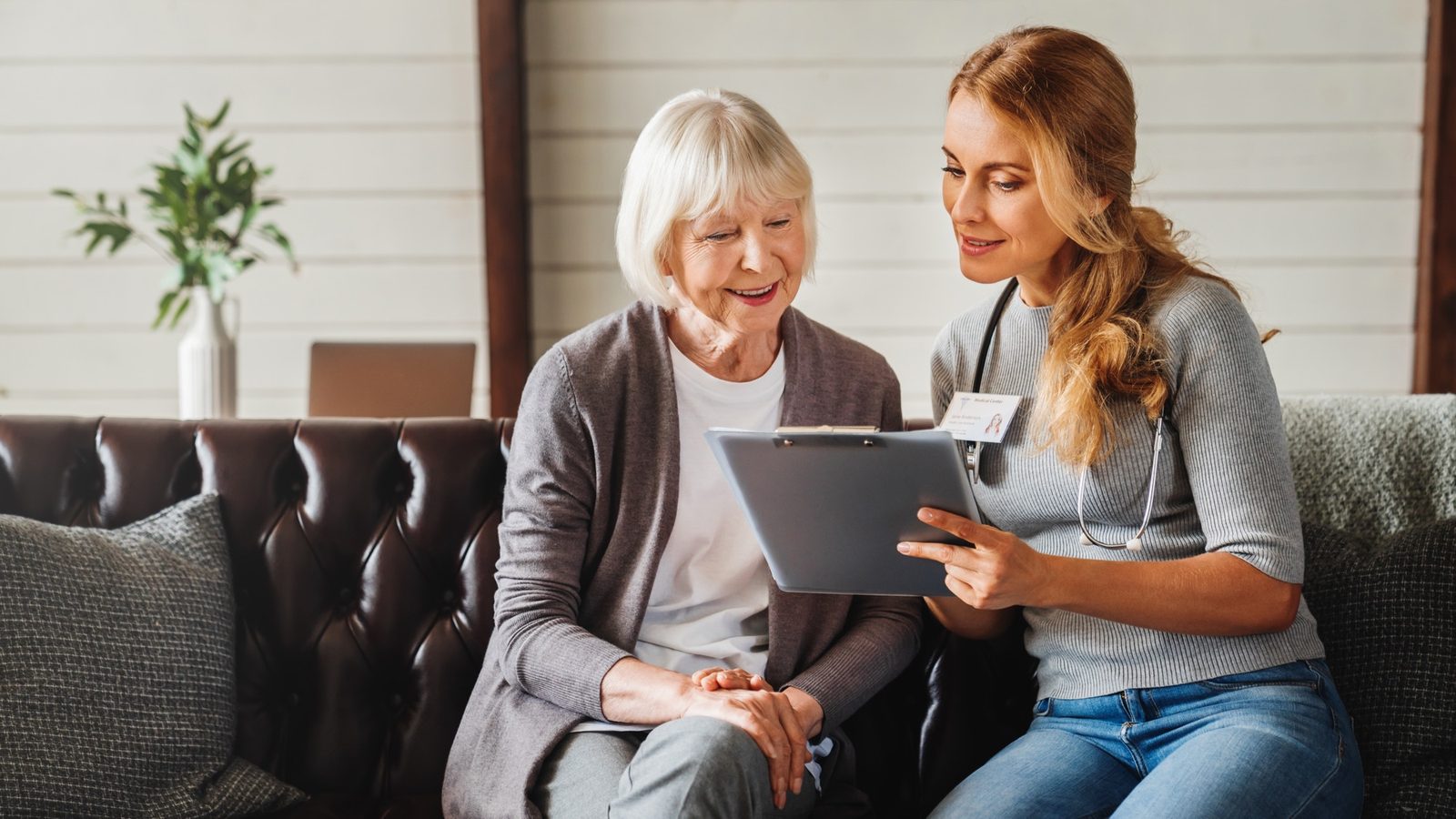 Clinician and member reviewing a care document together at home